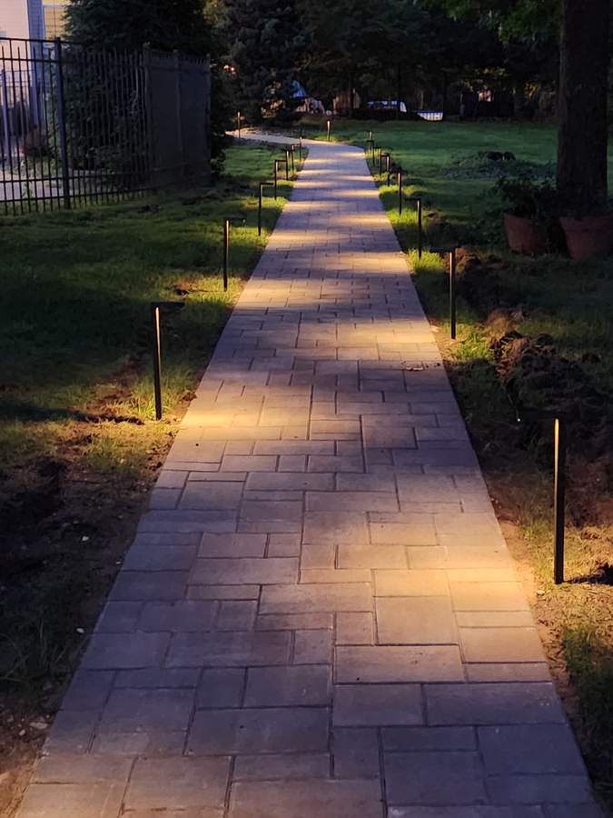 A home exterior with new pavers and siding