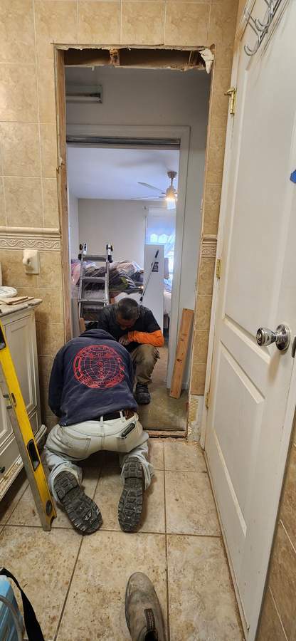 Crew member working on trim in a doorway