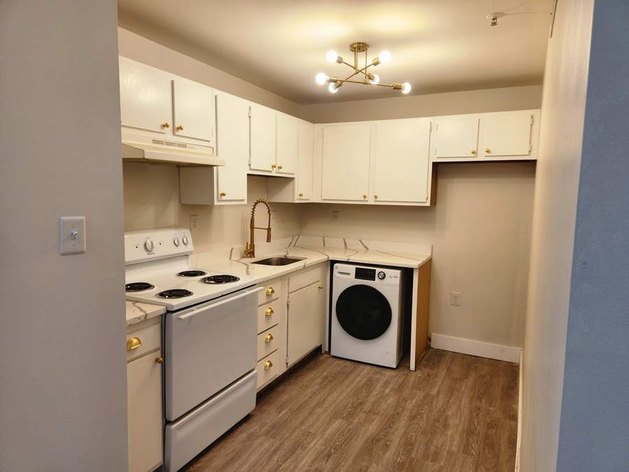 White kitchen with new flooring and laundry